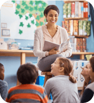 Teacher, reading book and school kids in a classroom for learning, education or story time. Happy woman teaching children or students about happiness, language and literature or development at school.