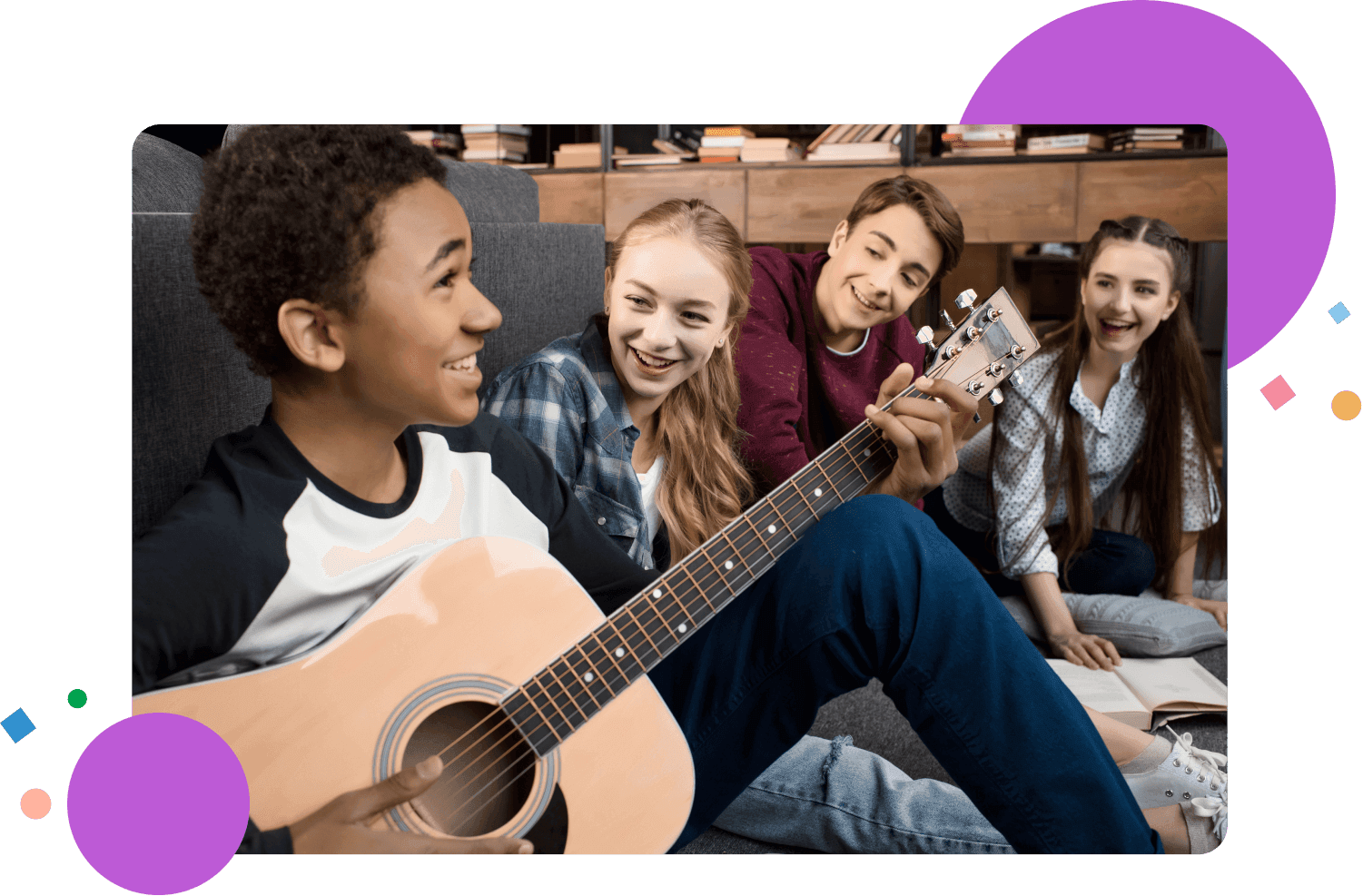 African American boy playing acustic guitar and singing while his friends listening at home, teenagers playing guitar concept