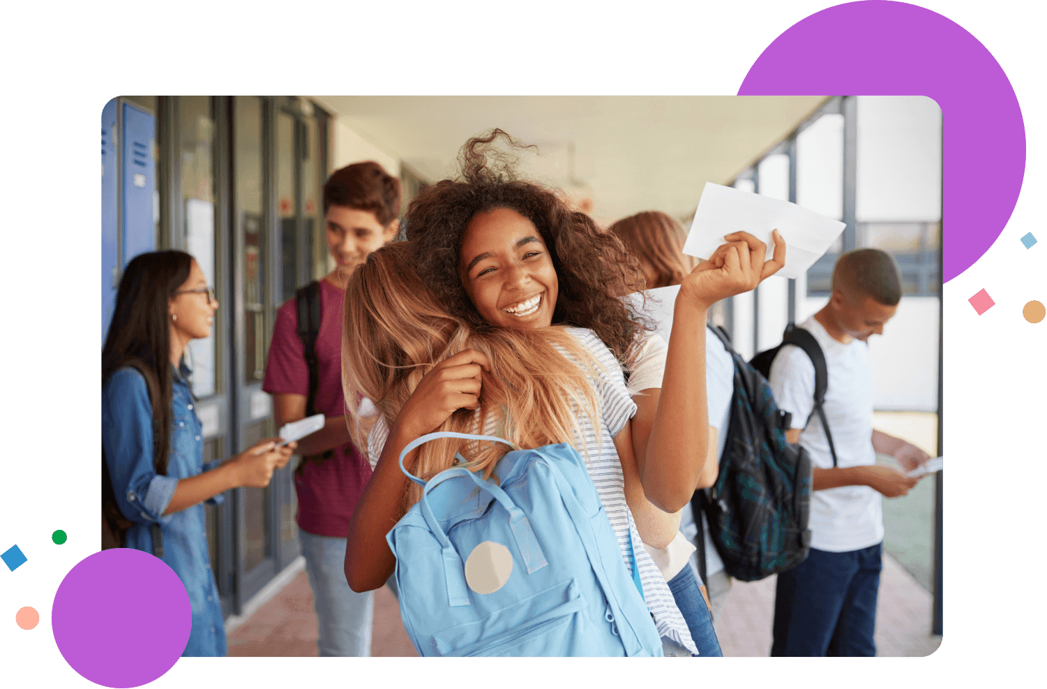 Two girls celebrating exam results in school corridor